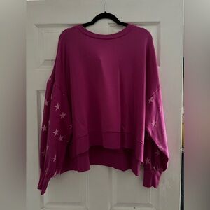 Pink sweatshirt with starts on arms